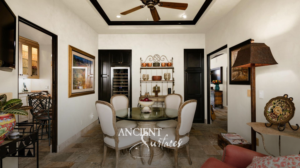 Dining room with reclaimed limestone floors in mixed formats opening through to the kitchen